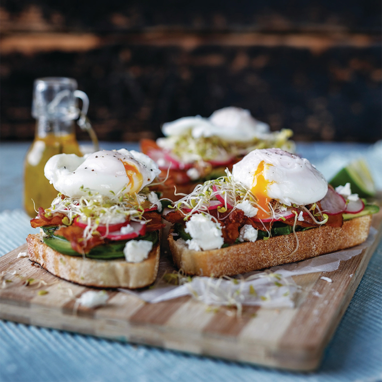 Smashed avocado toasts with feta, bacon and poached eggs
