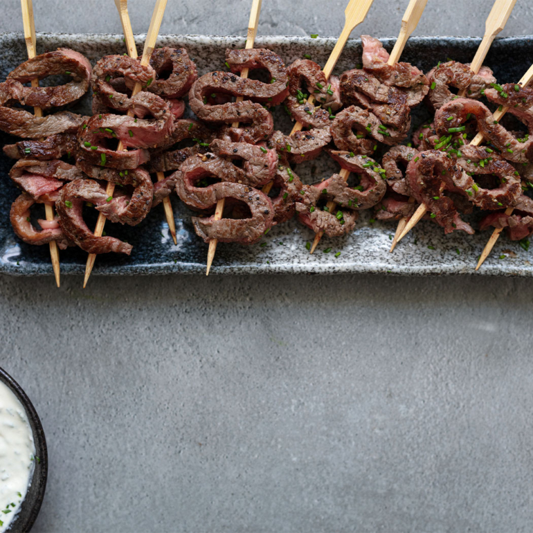 Seared beef skewers with horseradish crème fraîche dip