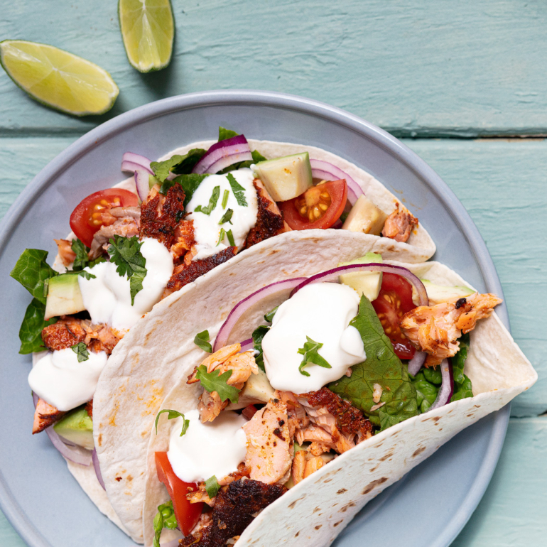 Blackened salmon tacos with lime sour cream drizzle