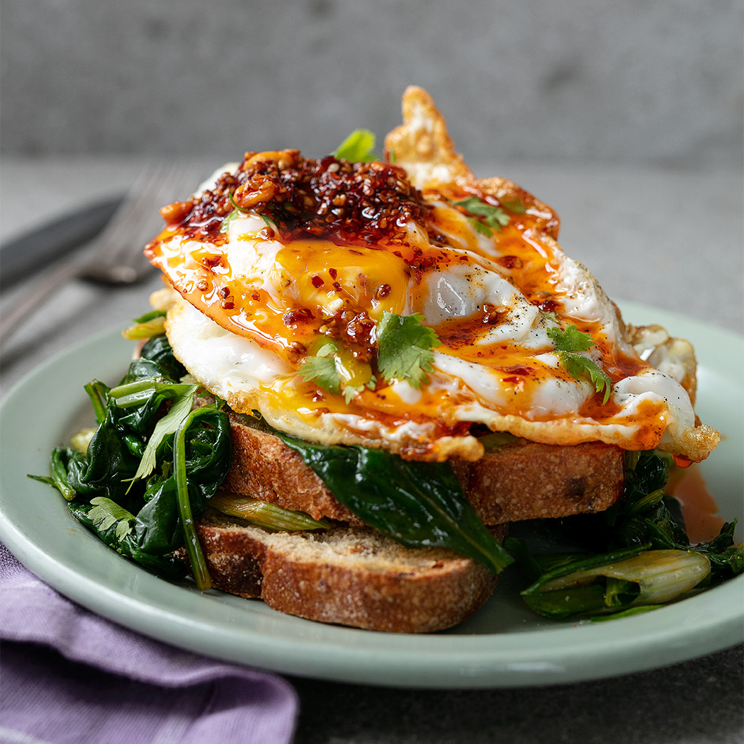 Crispy fried eggs with peanut rayu and greens | easyFood