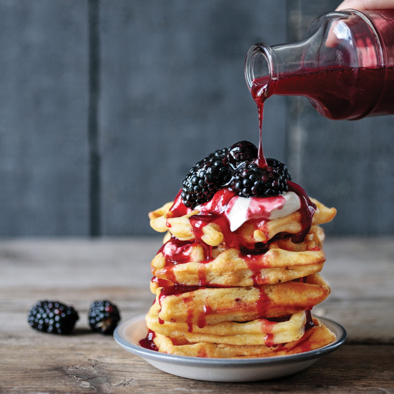 Homemade waffles with blackberry syrup