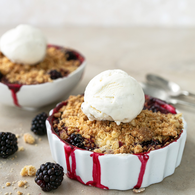 Individual plum and blackberry crumbles