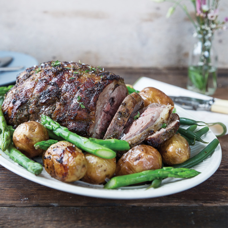 Roasted herbed leg of lamb with new potatoes