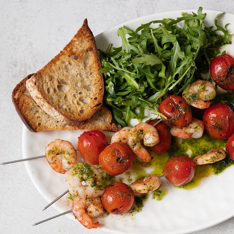 Tomatoes and prawn skewers with basil pesto
