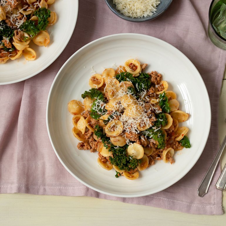Spicy pork with pasta & greens