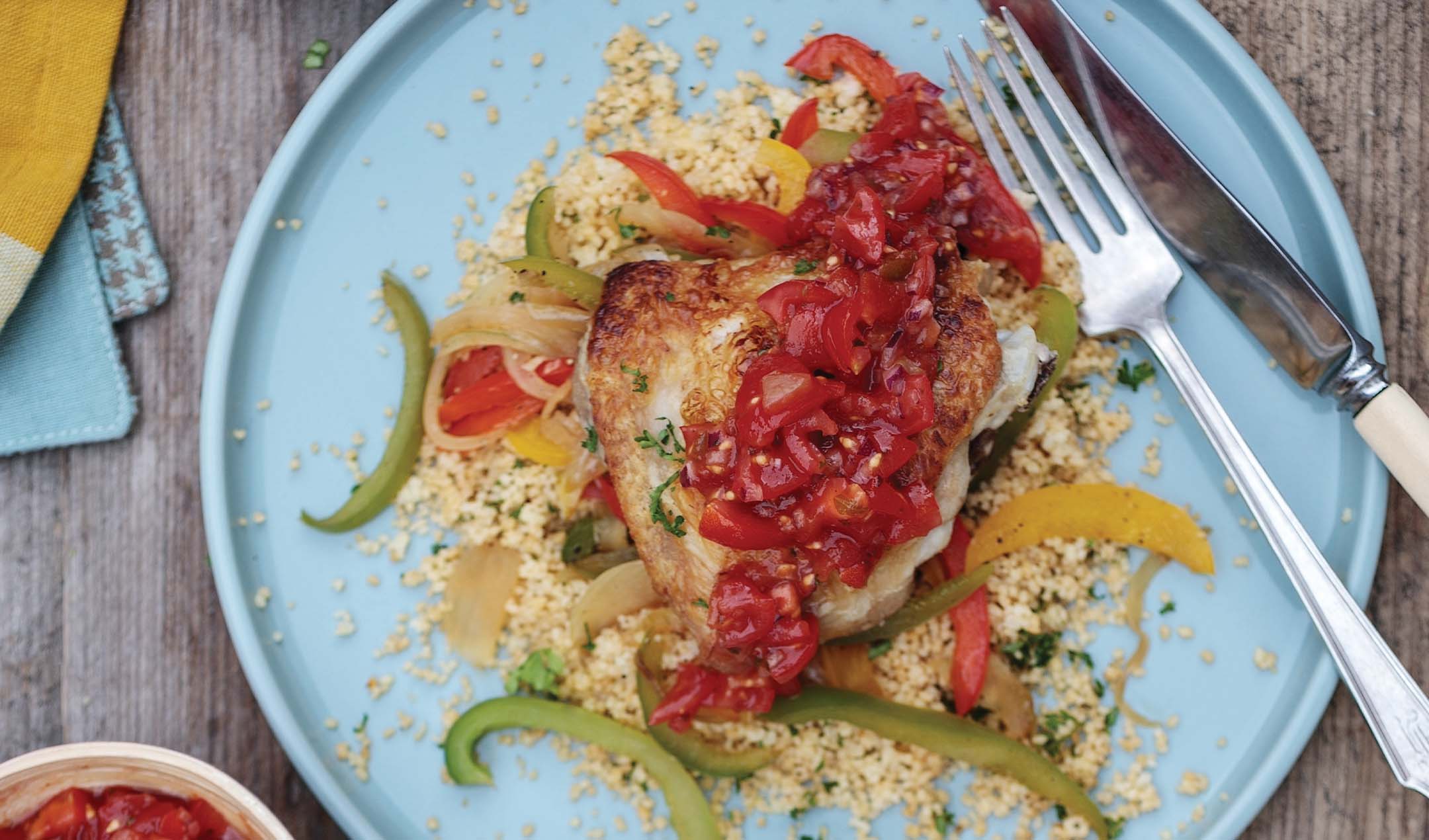 Crispy chicken thighs with peppers and couscous