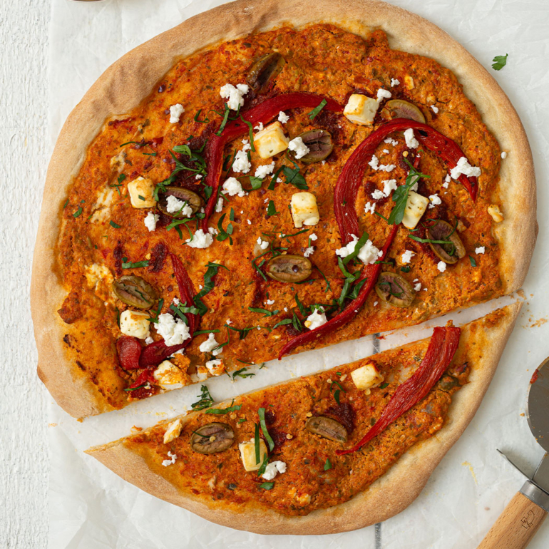Flatbread pizza with harissa, feta and olives